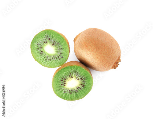 Cut and whole fresh kiwis on white background, top view