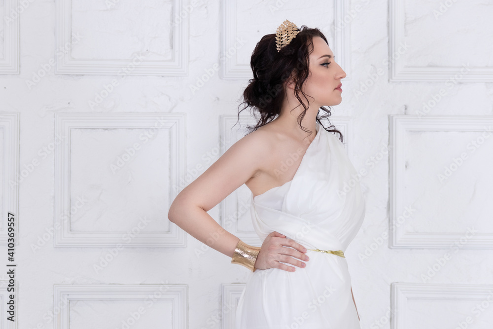 Beautiful Greek goddess woman close up among the white ancient ruins.Greek style woman. Beautiful Greek goddess woman close up among the white ancient ruins.Greek style woman.
