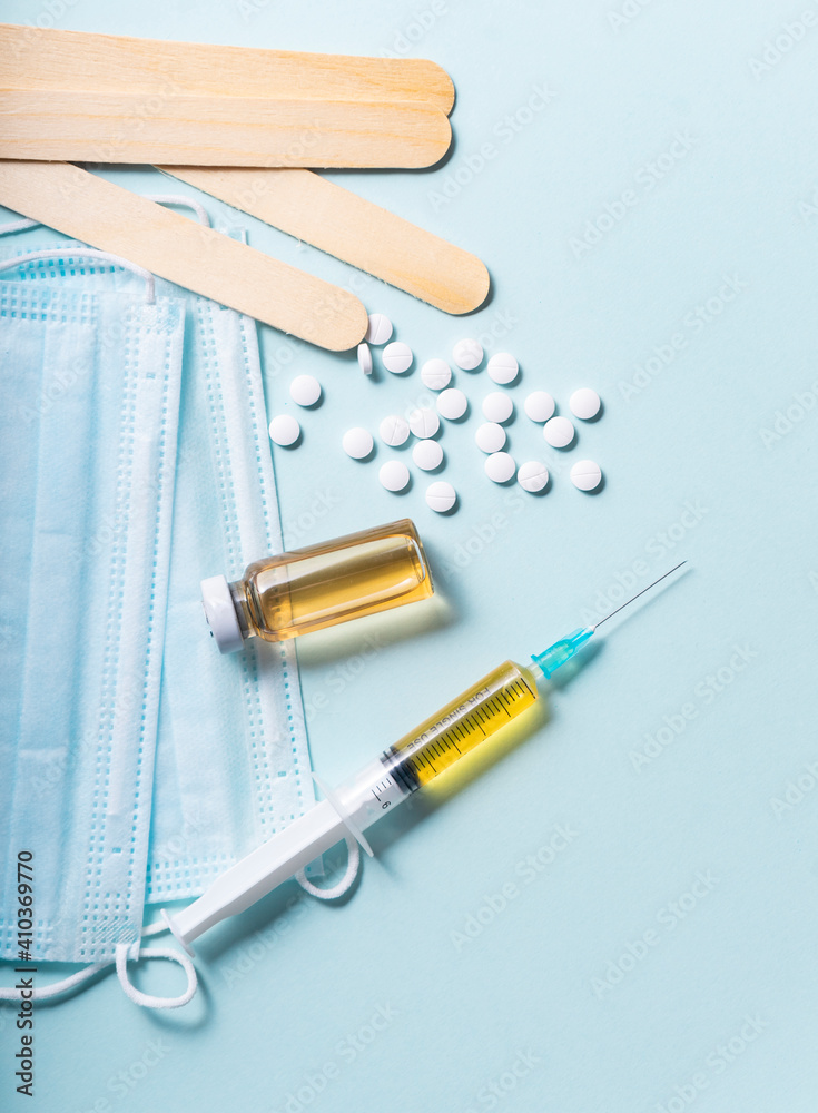 selective focus. a single-use syringe with a vaccine, a serum from the virus. Antiviral drug for Covid-19 and seasonal diseases. flatlay selective focus. a single-use syringe with a vaccine, a serum from the virus. Antiviral drug for Covid-19 and seasonal diseases. flatlay