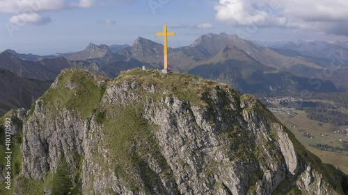 Tourists And Yellow Cross Standing At Pointe de Marcelly, A Summit Of Chablais Massif In France. drone approach photo