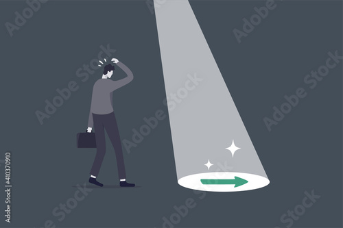 Business support or mentor help discover right direction, leadership to see business vision or career path concept, spotlight shining light on floor reveal arrow guidance to businessman in the dark.