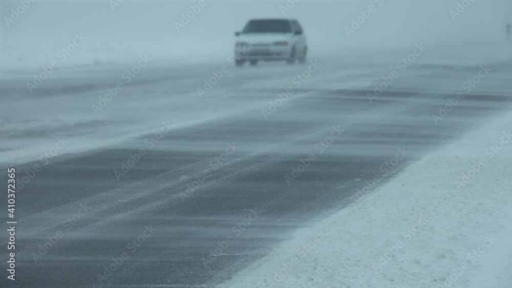 Cars moving on winter road at blizzard, 4k Cars moving on winter road at blizzard, 4k