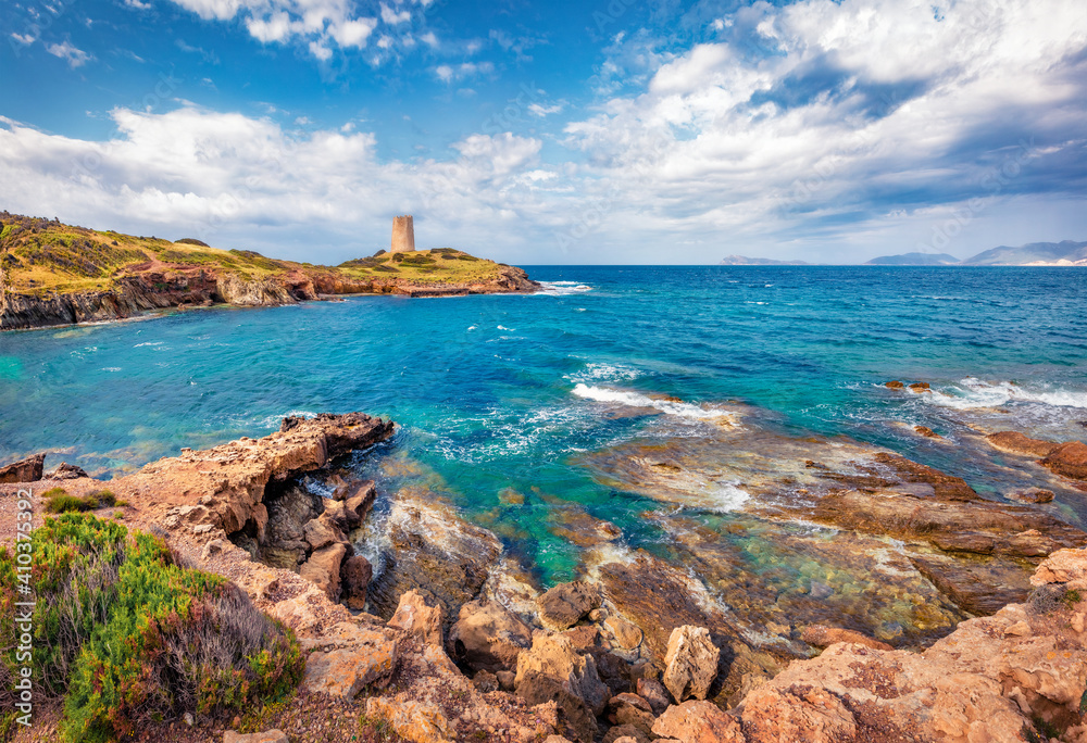 Beautiful marine scenery. Splendid morning view of Piscinni bay with Torre di Pixinni tower on background. Sunny summer scene of Sardinia island, Italy. Gorgeous Mediterranean seascape.