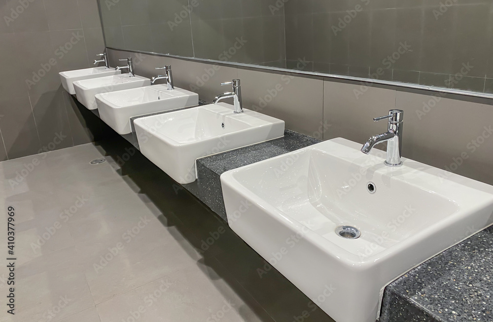 Fototapeta premium Public sinks, Handwashers for people using public toilets, Cleaning after using the toilet service, Public toilets and hygiene concept.