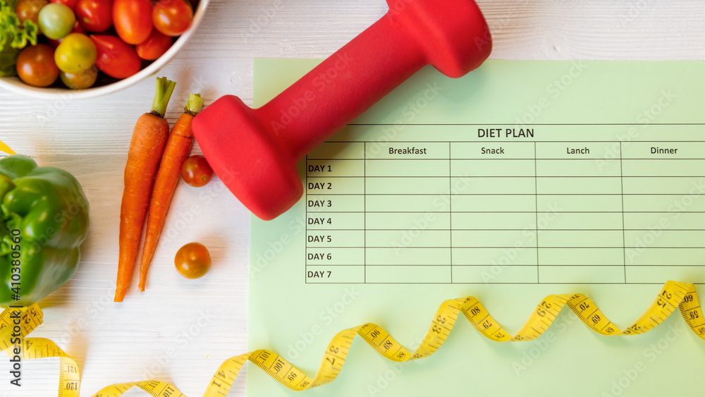 Diet Health Plan. Workout planing for stay at home. Sport exercise equipment workout and gym background with nutrition fresh salad for fitness style. Diet Health Plan. Workout planing for stay at home. Sport exercise equipment workout and gym background with nutrition fresh salad for fitness style.