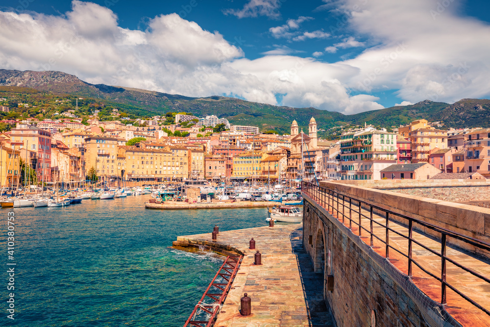 Сharm of the ancient cities of Europe. Adorable summer cityscape of Bastia port with twin-towered Church of St. Jean-Baptiste rising behind it. Captivating morning view of Corsica island, France.