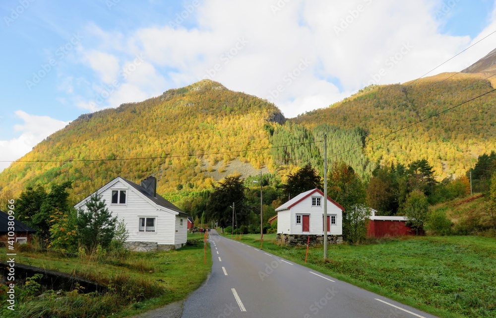 Wooden cabins along the road of the rural village Urke, Norway
