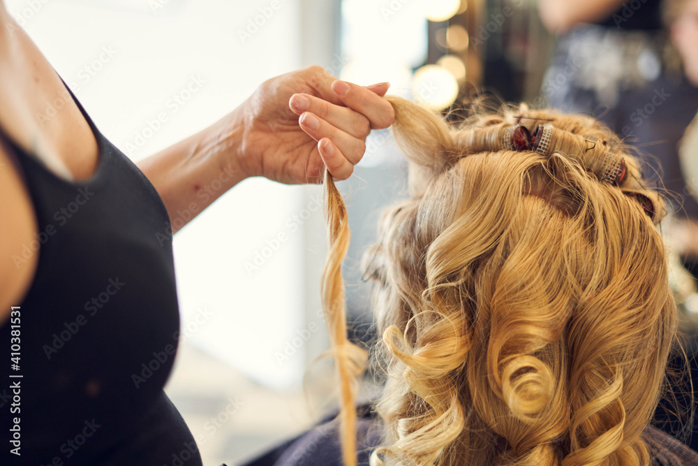 Naklejka premium Blonde lockige Braut beim Friseur, getting ready