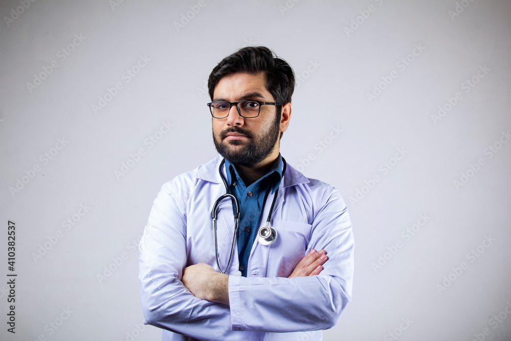 A doctor wearing stethoscope and medical coat looking forward A doctor wearing stethoscope and medical coat looking forward