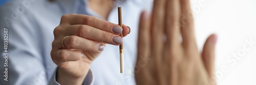Woman offers cigarette to man who makes negative gesture. The harm of smoking on the human body concept