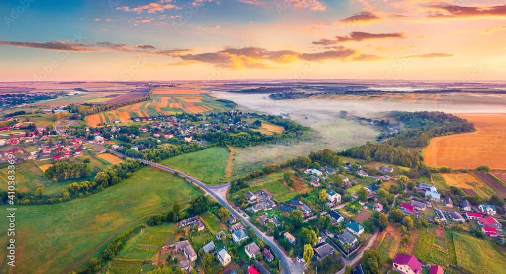 Aerial landscape photography Stunning dawn on Ukrainian countryside with foggy fields. Attractive summer sunrise on outskirts of Ternopil town, Ukraine, Europe. Traveling concept background.