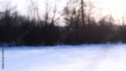 diamond dust with winter landscape in the background, ice crystals falling and sparkling in rising sun, rare meteorological phenomenon