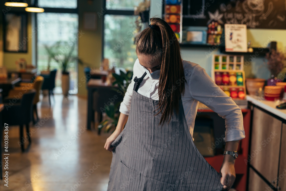 waitress preparing for work in restaurant or cafe waitress preparing for work in restaurant or cafe