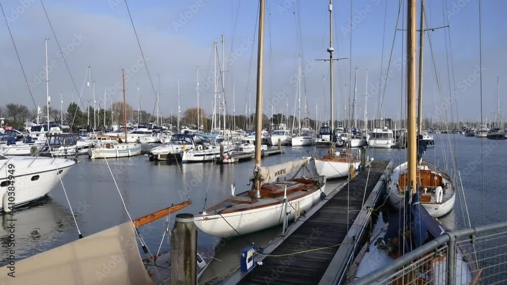 Elegant Sailing Boats moored on a Jetty at the popular sailing destination at Chichester Marina. Elegant Sailing Boats moored on a Jetty at the popular sailing destination at Chichester Marina.