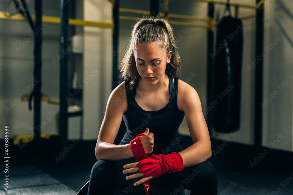 Fototapeta premium woman preparing for training in gym