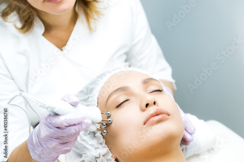 Woman at a beautician's appointment. Non-surgical face lifting. microcurrent facial therapy