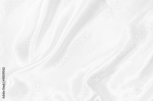 White fabric is satin or silk abstract background which has wrinkles that are very smooth and clean with soft wave design