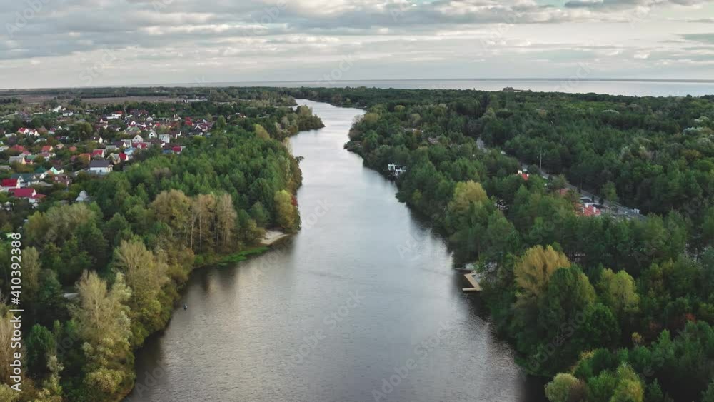 River at green leaf forest aerial. Nobody nature landscape. Autumn colorful park at urban streets. Cityscape with downtown buildings, cottages. Cinematic Dnieper, Kiev city, Ukraine, Europe River at green leaf forest aerial. Nobody nature landscape. Autumn colorful park at urban streets. Cityscape with downtown buildings, cottages. Cinematic Dnieper, Kiev city, Ukraine, Europe