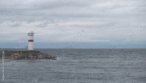 Panorama of the lighthouse on a cloudy day in Istanbul, Turkey. One of the lighthouses on the breakwaters. Advertising banner or poster with copy space. Flying seagulls. Bosphorus and Sea of Marmara.