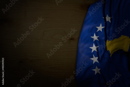 Fototapeta Naklejka Na Ścianę i Meble -  beautiful any celebration flag 3d illustration. - dark illustration of Kosovo flag with large folds on dark wood with empty space for your content