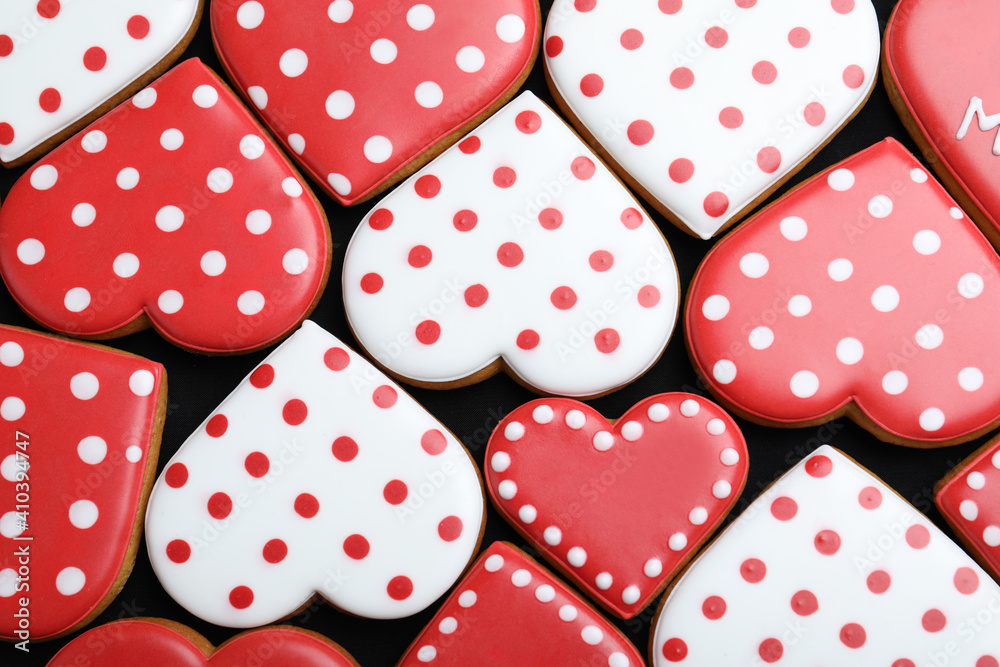 Delicious heart shaped cookies on dark background, flat lay. Valentine's Day