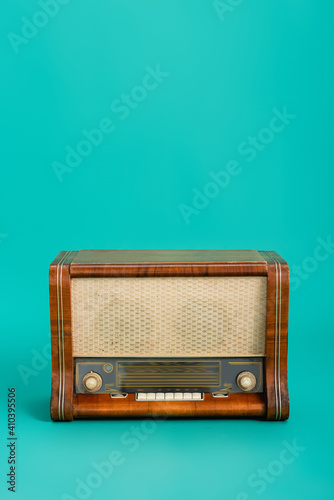 wooden radio on turquoise background with copy space