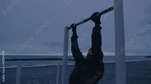 Person is working out. Training on open air at nasty weather photo