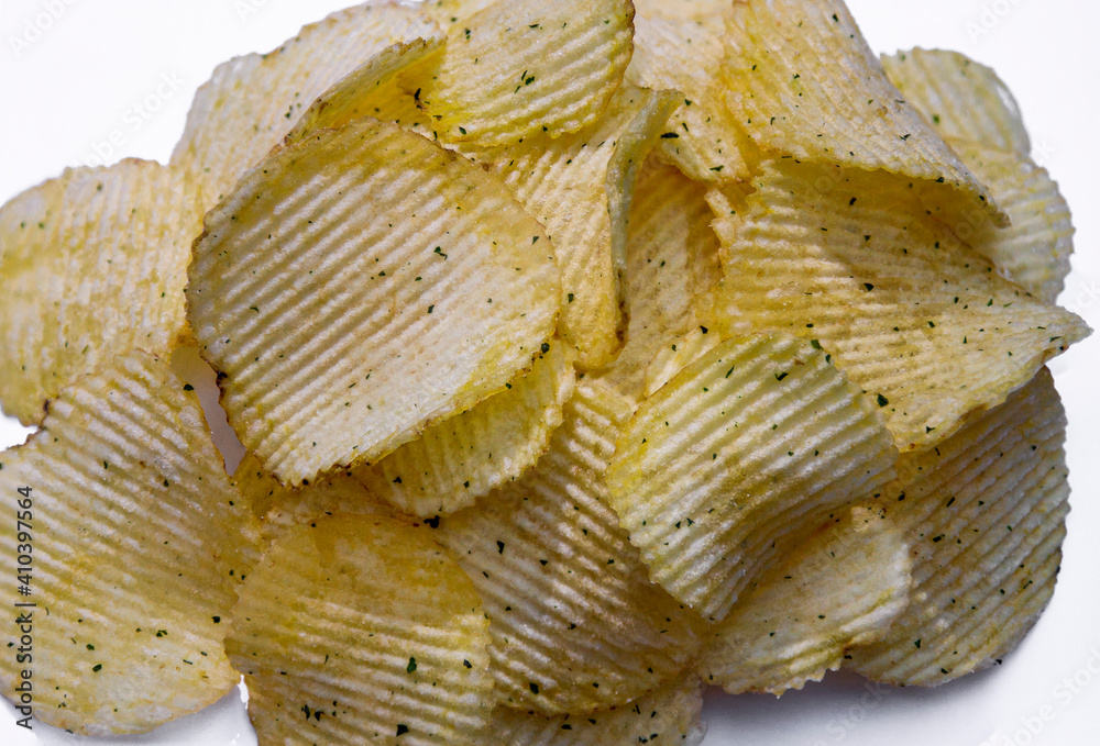 potato ribbed chips with dill on a white plate