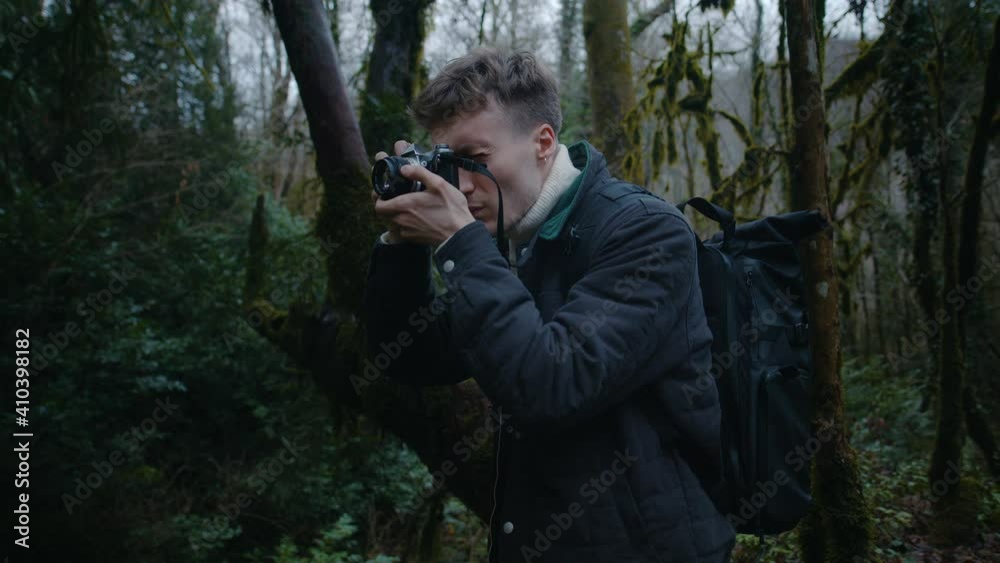 Portrait of guy taking photos in the forest, film photographer in forest Portrait of guy taking photos in the forest, film photographer in forest