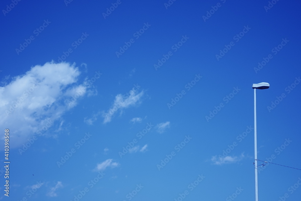 lamp post against blue sky