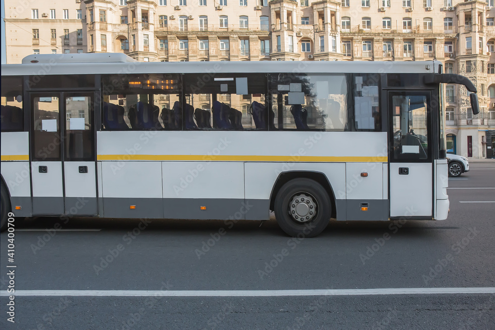 bus rides along the street in the city