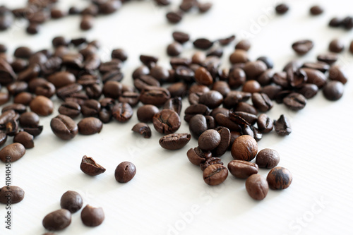 roasted coffee beans on white wooden background