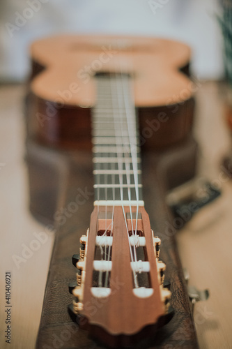 Expensive acoustic guitar in the home interior. Guitar case, close up of the strings