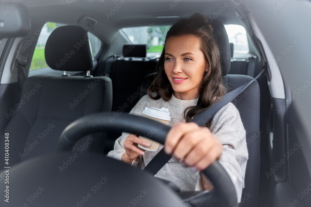 lifestyle and people concept - happy smiling young woman or female driver driving car and drinking takeaway coffee