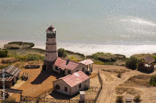 Obraz na płótnie Lighthouse at the beach at the sea w salonie