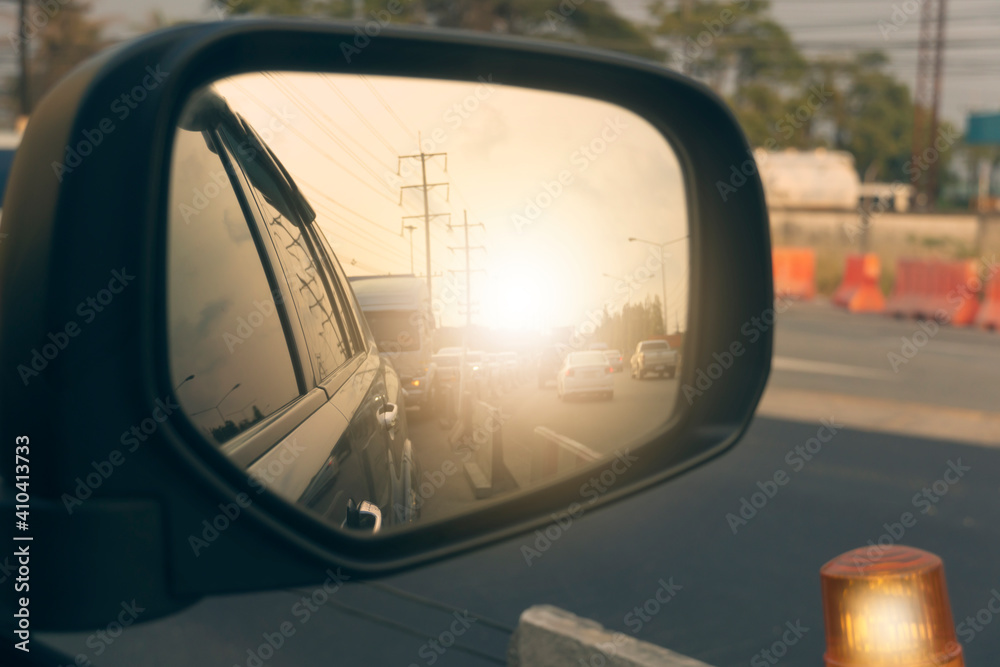 Side view of car mirror with traffic on the streets, there are many cars. and environment of construction time on the road. Side view of car mirror with traffic on the streets, there are many cars. and environment of construction time on the road.