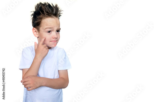 A boy in a white T-shirt and with spiky hair shows a mixed emotion. The child was conceived. Space for your text. Isolated on a white background