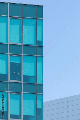 Close-up of an anonymous office building in Madrid, Spain, under the scorching summer sun. A closed work space, sterile for life and built with concrete, steel and glass.