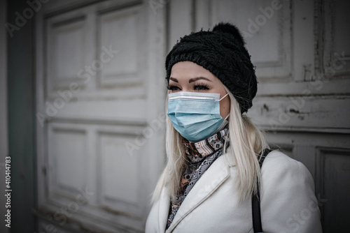Optimistic young woman going to the town wearing face mask due to covid-19 pandemic