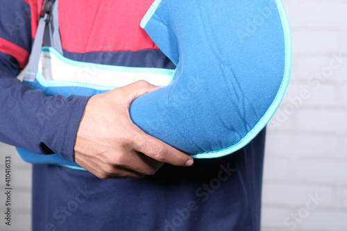 young man wearing an arm brace for broken hand .