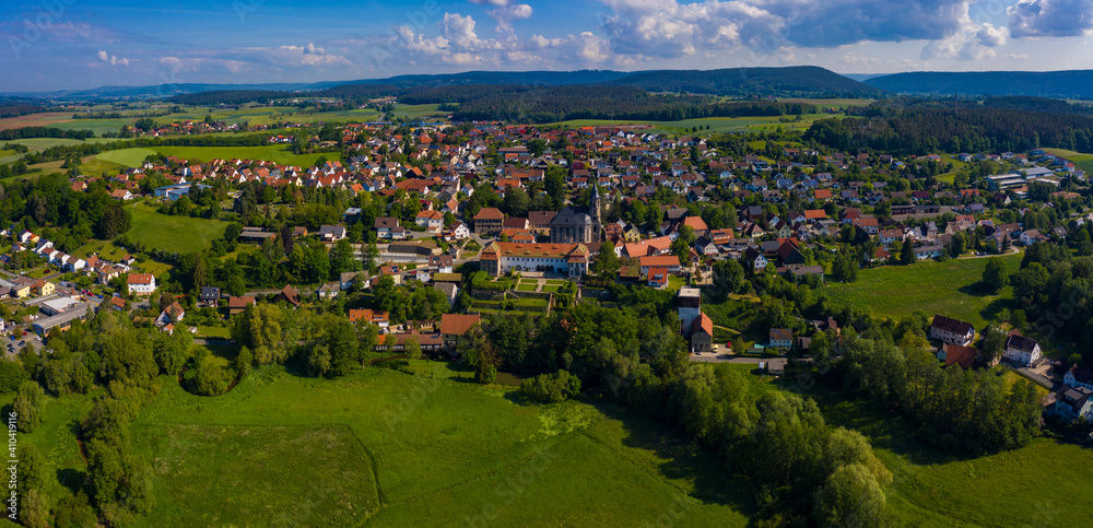 Aerial view of the city and monastery Neudrossenfeld in Germany on a sunny day in spring.	