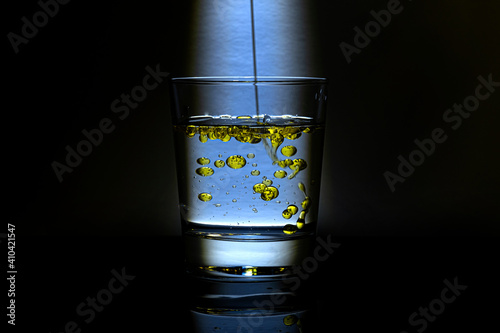 golden drops of oil background or surface in glass
