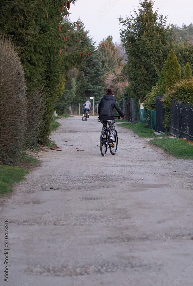 the woman is riding a bicycle on a country road 