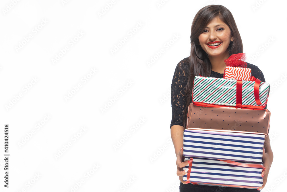 Portrait of young woman holding gift boxes Portrait of young woman holding gift boxes