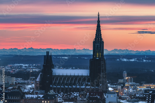 Ulm with Minster curch at sunrise with colorful sky and alps in the background