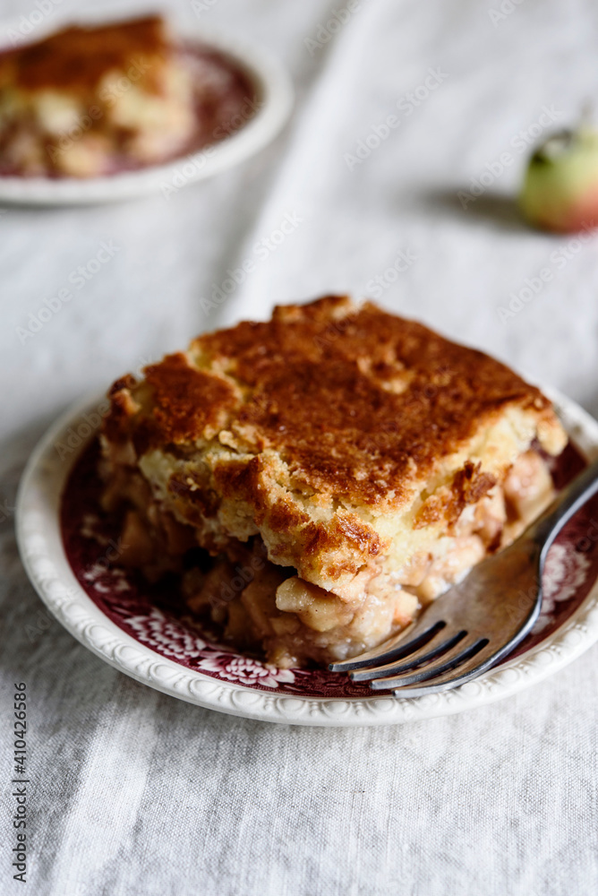 Apple and Cheese Cobbler Crisp. Cobbler or Crumble dessert with apples on plates on beige linen table. Selective focus