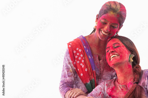 TWO WOMEN HAPPILY POSING TOGETHER AFTER CELEBRATING HOLI 