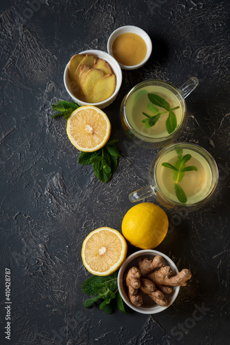 Ginger tea with mint, lemon and honey on concrete background. Top view