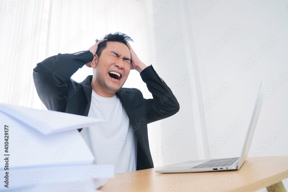 Angered Asian man working in office,He’s looking at laptop and screaming, bad emotional, a lot of work, fighting with college Angered Asian man working in office,He’s looking at laptop and screaming, bad emotional, a lot of work, fighting with college