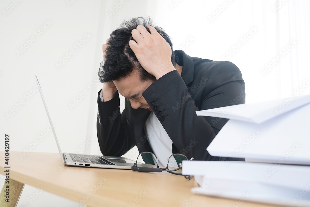 Angered Asian man working in office,He’s looking at laptop and screaming, bad emotional, a lot of work, fighting with college Angered Asian man working in office,He’s looking at laptop and screaming, bad emotional, a lot of work, fighting with college